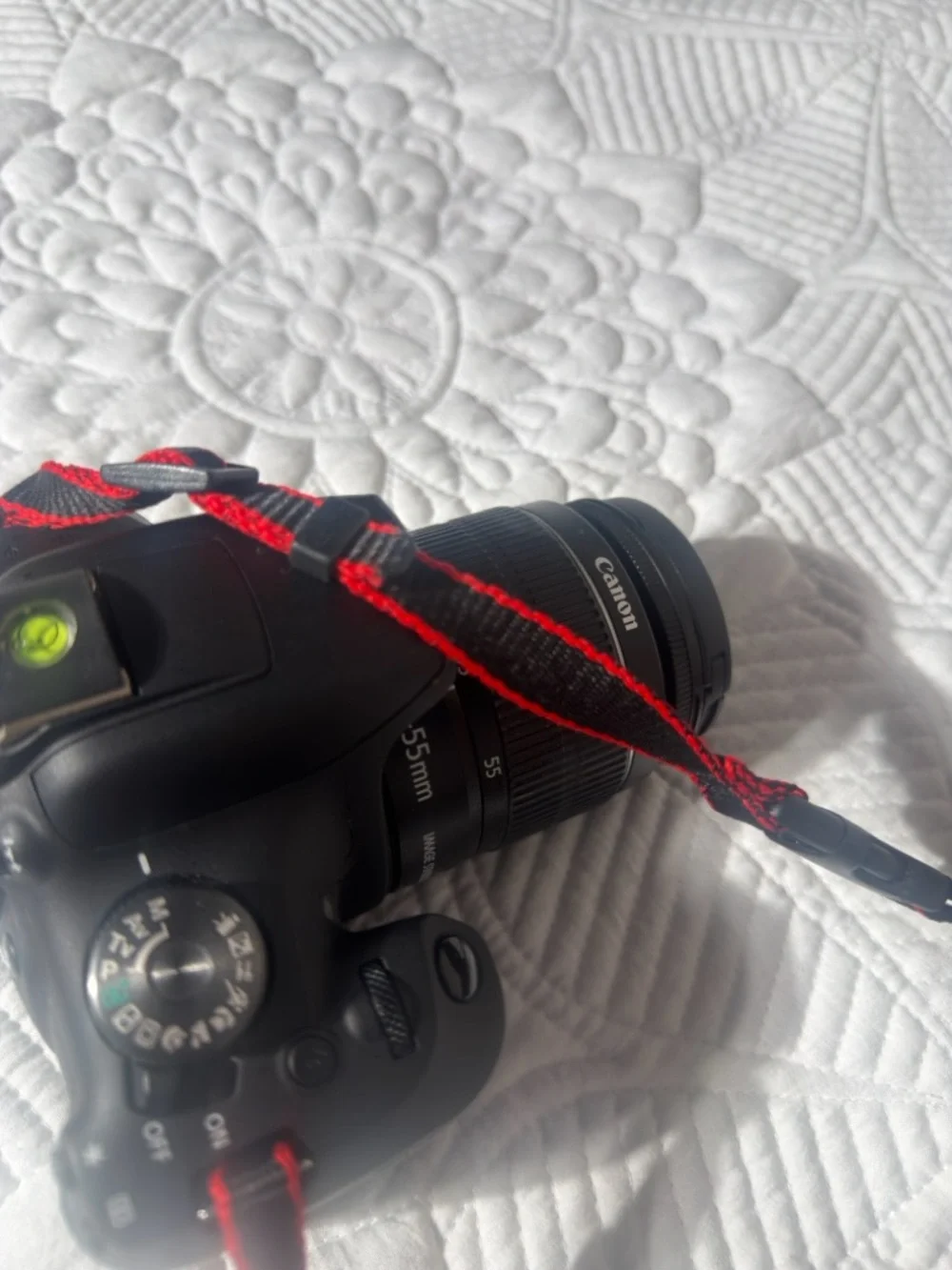 Canon Black DSLR Camera with Zoom Lens and Red-Trim Strap